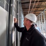 Matt Weaver signs a blessing wall