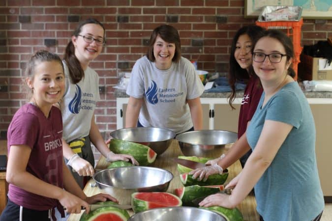 Anna Haarer and 8th grade students prepare snacks for elementary students as part of Community Service Day.