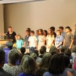 Heidi Byler, grade 3, leads the group in singing, "You are salt of the earth, oh people!"