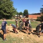 Eighth grade science class works on EMES playground tire project.