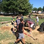 Eighth grade science class works on EMES playground tire project.
