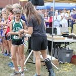 Katie Cimini hands award to the winner of the middle school race.