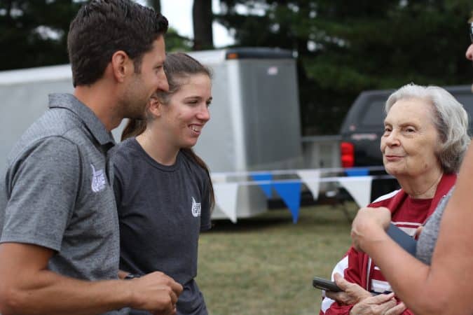 Andrew Gascho and crosss country coach, Katie Cimini, visit with Mrs. Burtner of the Burtner Farm cross country course in Penn Laird.