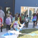 Students taking supplies to the new building.