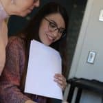 Valeria Eshelman-Robles reviews with a colleague some of the letters that her Spanish students wrote to children on the US/Mexico border.