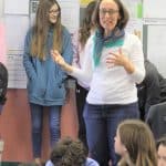 Luann Bender, class of '81, instructs 38 7th graders on how to get started with knotting comforter tops.