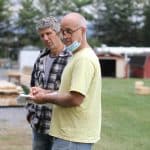 EMS dad Dwight Huyard (right) consults with Sam Petersheim, as they begin to build the outdoor stage. 