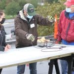 Malea Gascho (art teacher), Justin King (high school principal) and Kevin King (Justin's dad) at the solar barn raising