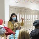 Julianne Ross greets 4th graders on a visit to the upper building library