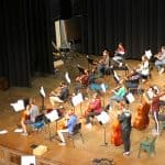 Nov. 23, orchestra performs for the faculty and staff, in the balcony