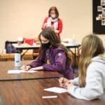 Safely distanced and masked, Christmas Fund Drive letter writing. 