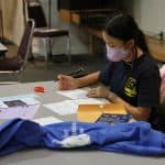 Safely distanced and masked, Christmas Fund Drive letter writing. 