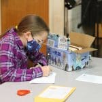 Safely distanced and masked, Christmas Fund Drive letter writing. 