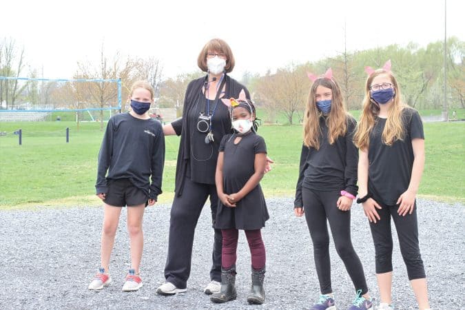 Joy Anderson, music teacher and theatre director, with student actors after the show.