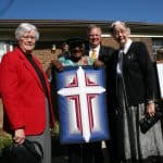 Brownie Driver, Desmond Tutu, Loren Swartzendruber, Gladys Driver. EMU President Swartzendruber presented a quilted wall hanging by the sisters to the Archbishop during a visit to JMU's Ghandi Peace Center, September 2007. Photo courtesy of Eastern Mennonite University.