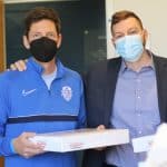 Andrew Gascho and Justin King prepare to hand out Krispy Kreme donuts to celebrate school spirit