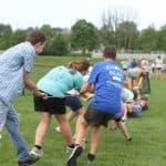 Elementary Field Day with older students setting up and running stations