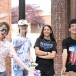 Elementary Field Day with older students setting up and running stations