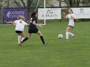 Varsity Girls Soccer in front of Athletic Banners