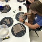 Students create raku ceramic tile quilt squares
