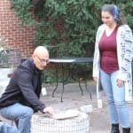 Herb Weaver and Malea Gascho with raku kiln in EMS courtyard.