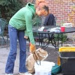 A student helps to empty the kiln