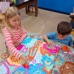 Title: Rainbow Rocket
Size: 24”x18”
Medium: acrylic paint
Description: Kindergarten artists worked in small groups to paint abstract designs directly on a cradled wooden panel. Beginning at the edges and working inward they painted large patches of color as a base layer. Additional layers were created using small blocks of color along with line, shape, and pattern designs. Students were thoughtful in selecting colors that would stand out next to each other, and  they enjoyed talking together about their painting. As the final step in their creative process, the class brainstormed title ideas for their piece then voted for their favorite.
