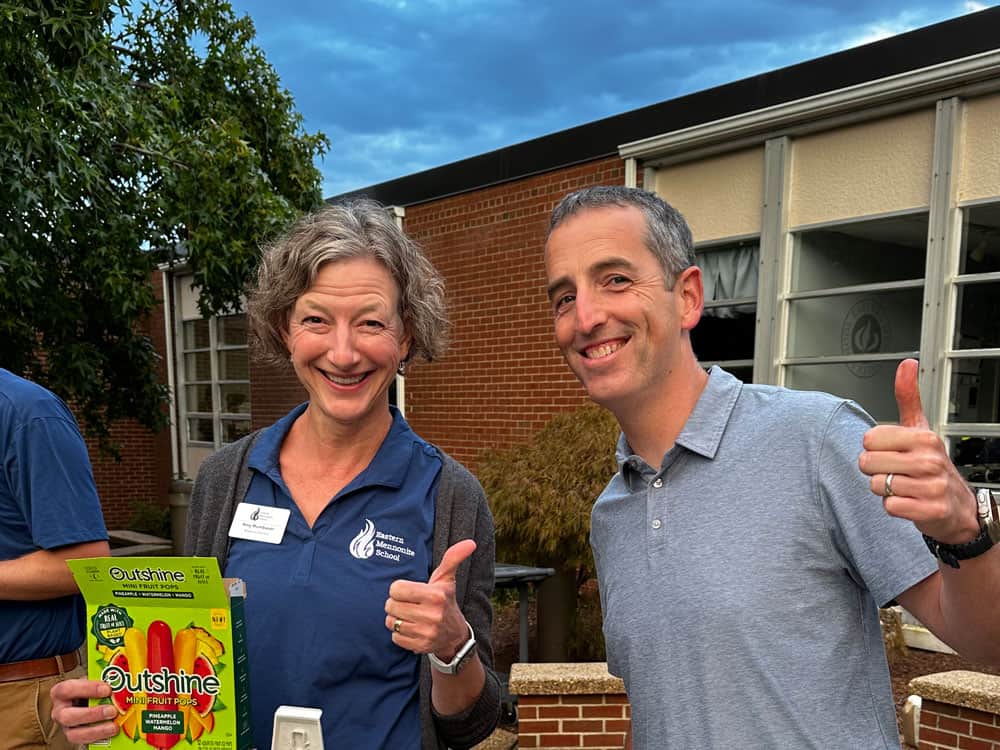 Board Chair Amy Mumbauer and Scott Rogers give a thumbs up at back-to-school night.