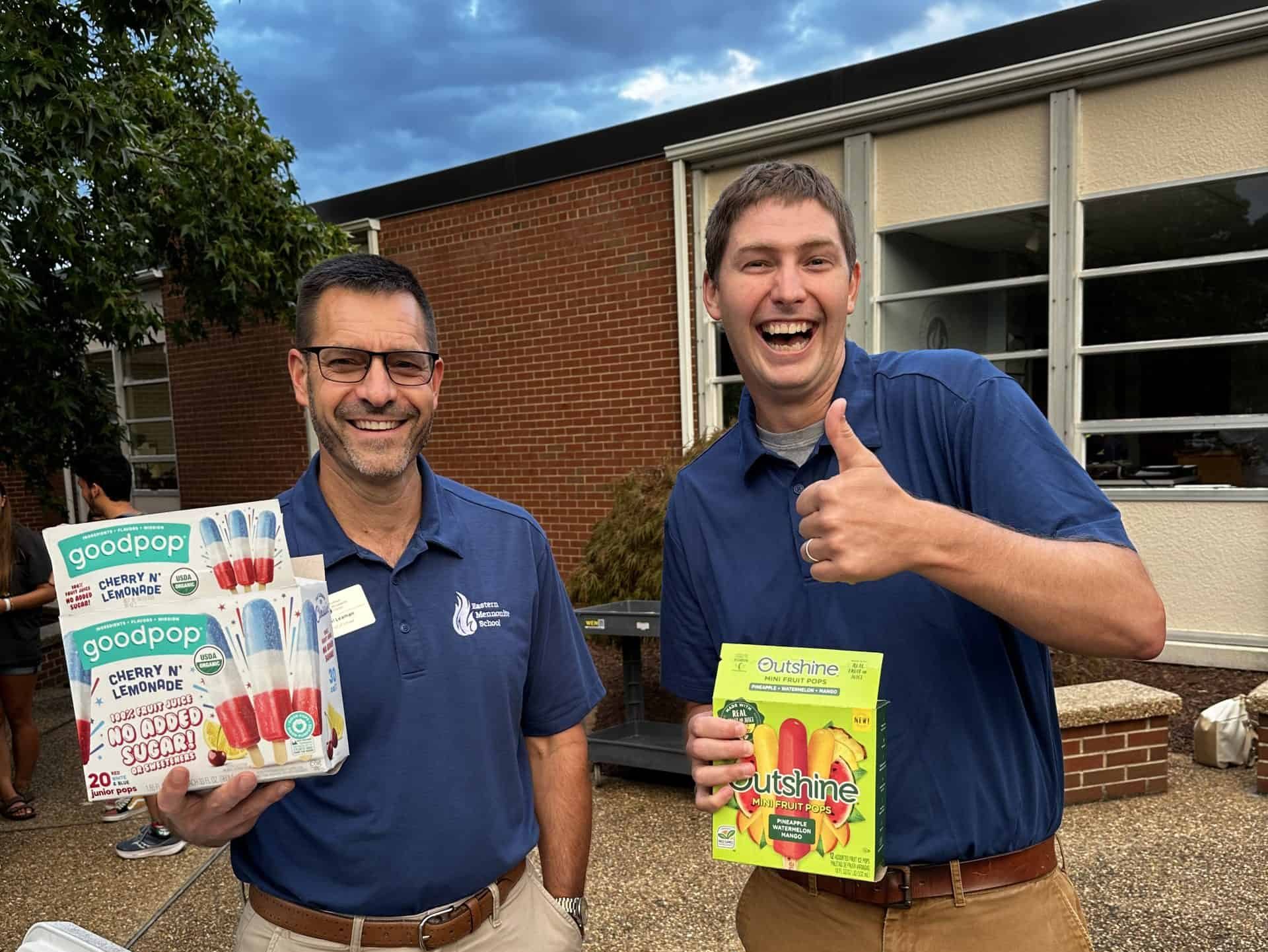 Head of School Paul Leaman and Kendal Swartzendruber hand out popsicles at back-to-school night.